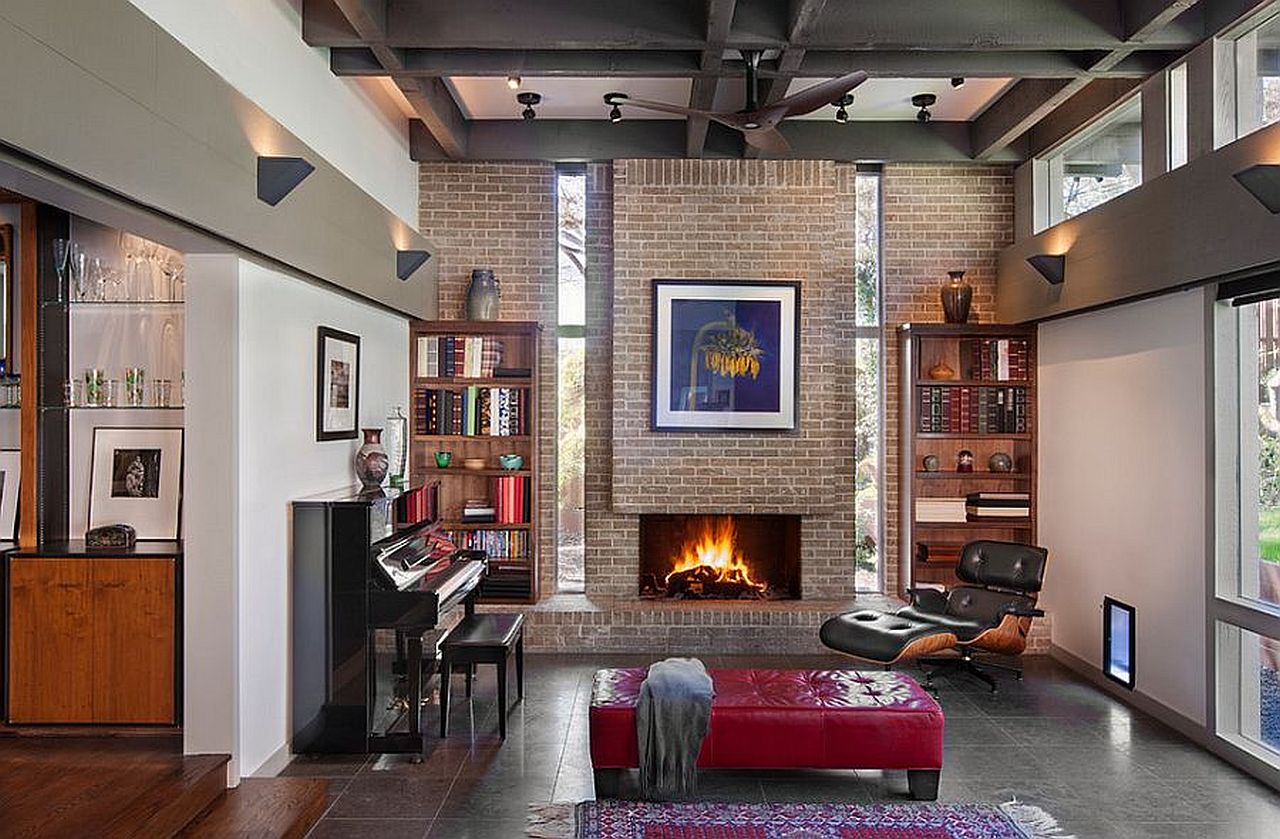 Double-height living room with brick wall and fireplace