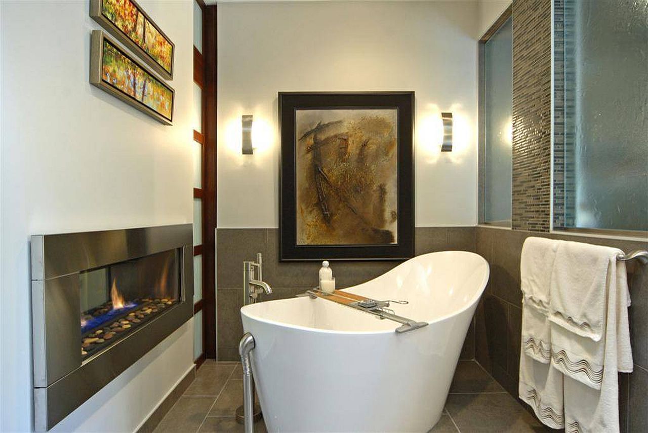 Small contemporary bathroom with freestanding bathtub and minimal fireplace