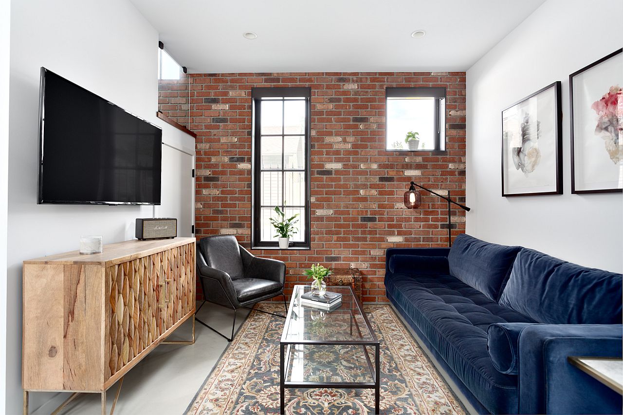 Small contemporary living room in white with brick wall 