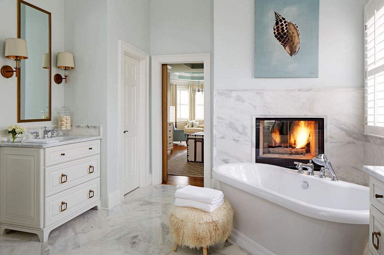 Tiny fireplace makes an impression in the neutral transitional bathroom