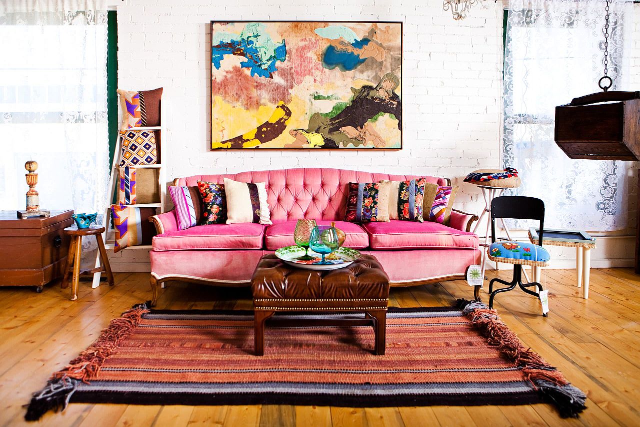 Wall art and pink couch add color to this small living room