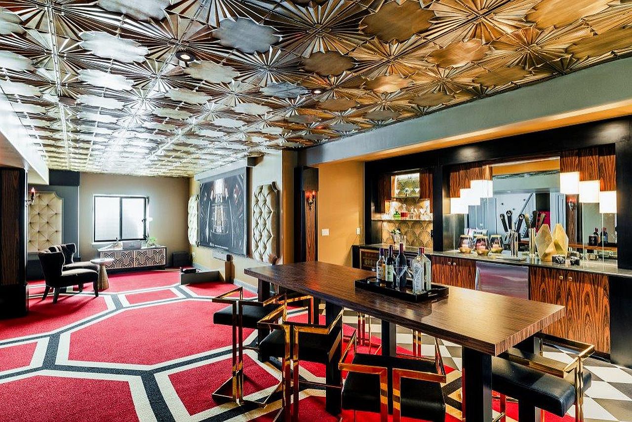 Custom ceiling of home bar brings ample metallic dazzle to this art deco room