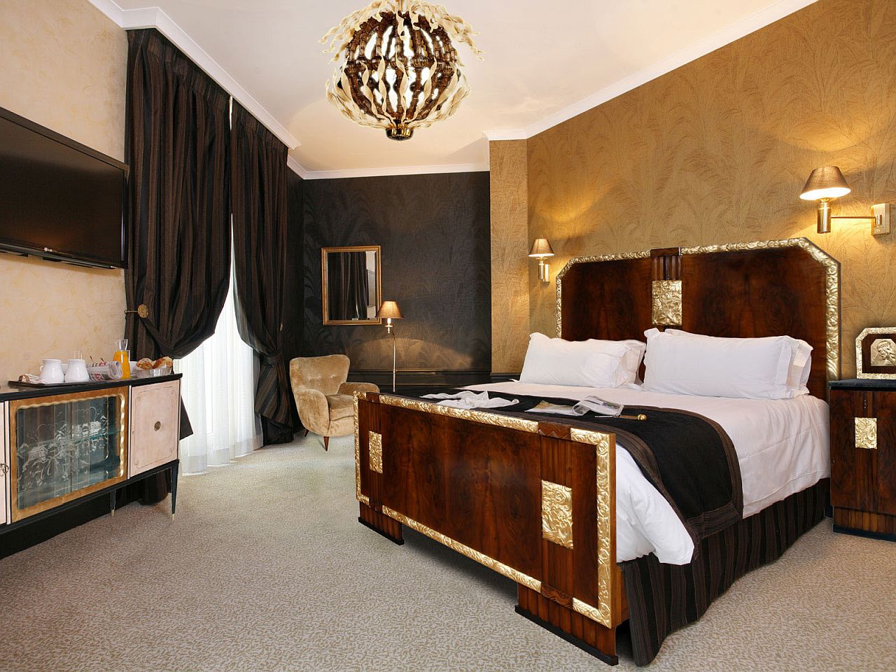 Golden wallpaper in the backdrop adds opulence to this art deco bedroom