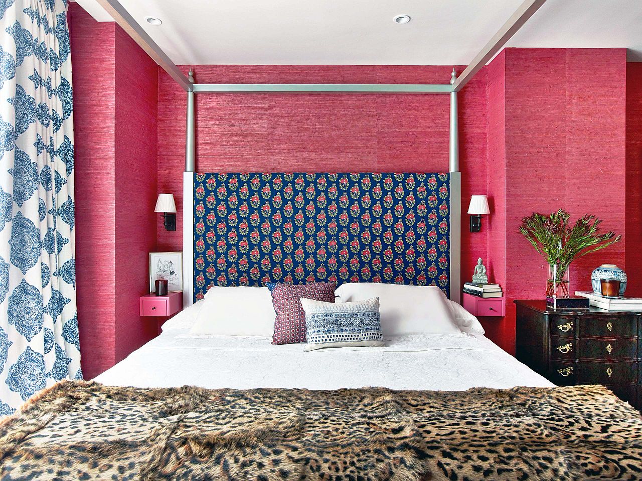 Grasscloth wallpaper covers the accent wall of this bedroom giving it visual and textural contrast