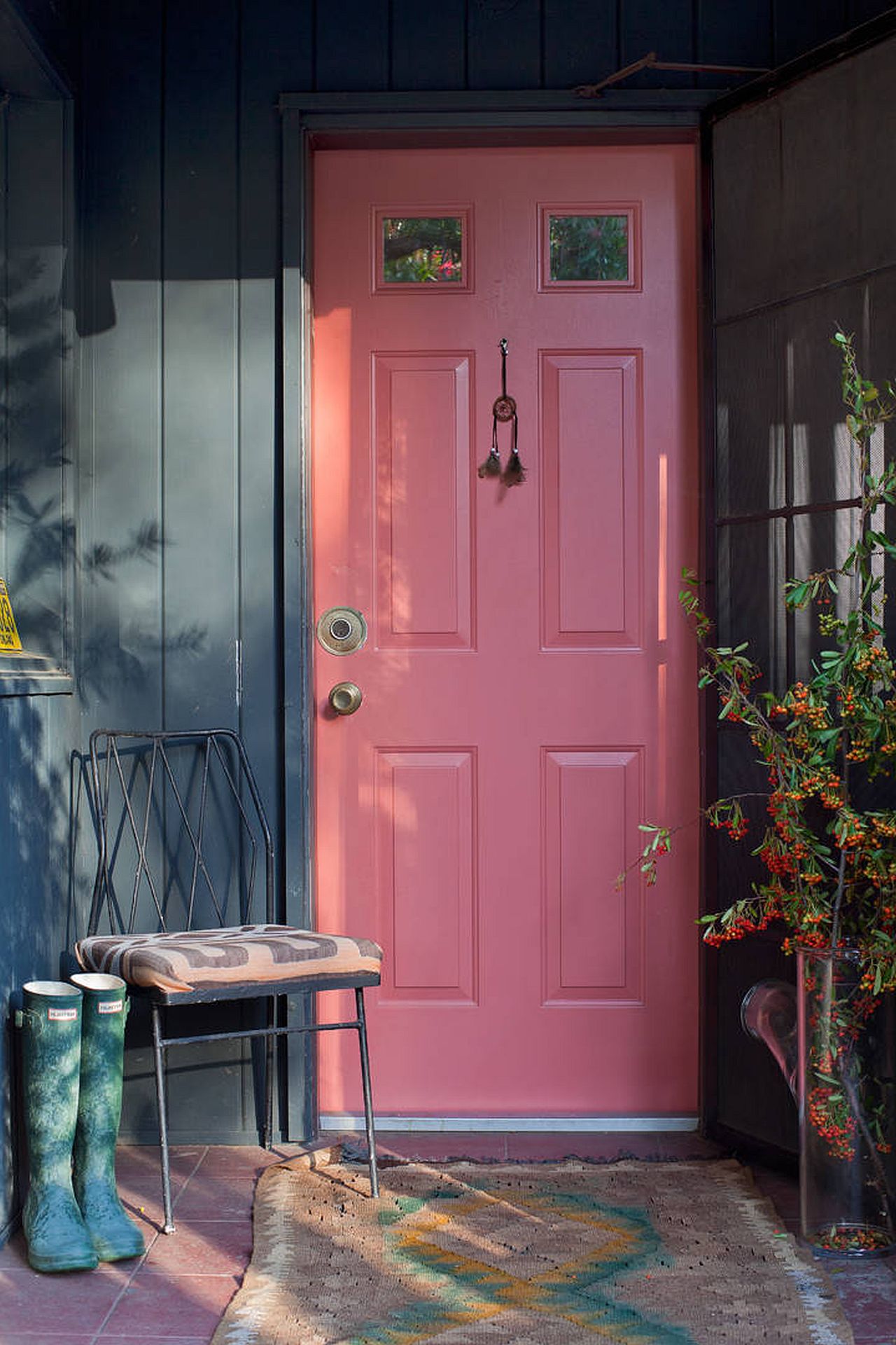 Pink door coupled with a gray exterior presents a picture of modernity