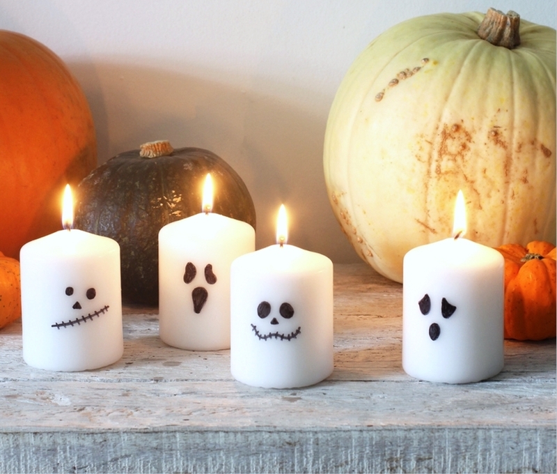 Halloween Candles with Spooky faces on them  