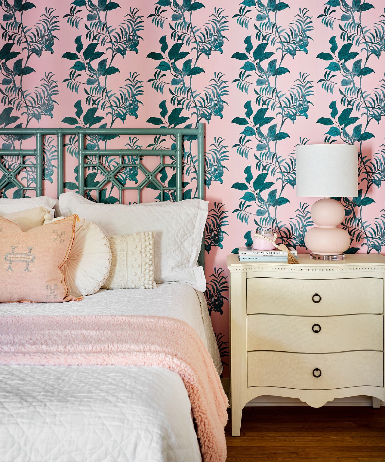 Wallpaper in pink with green, leafy motifs bring pink to this bedroom