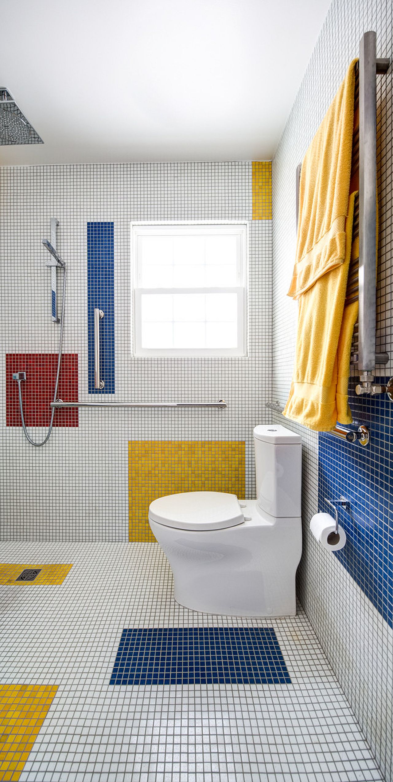 Blocks of bold color enliven the monochromatic white bathroom