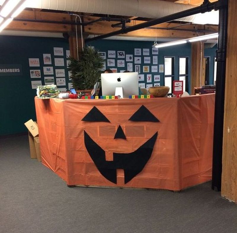 A spooky jack-o-lantern face on the cubicle