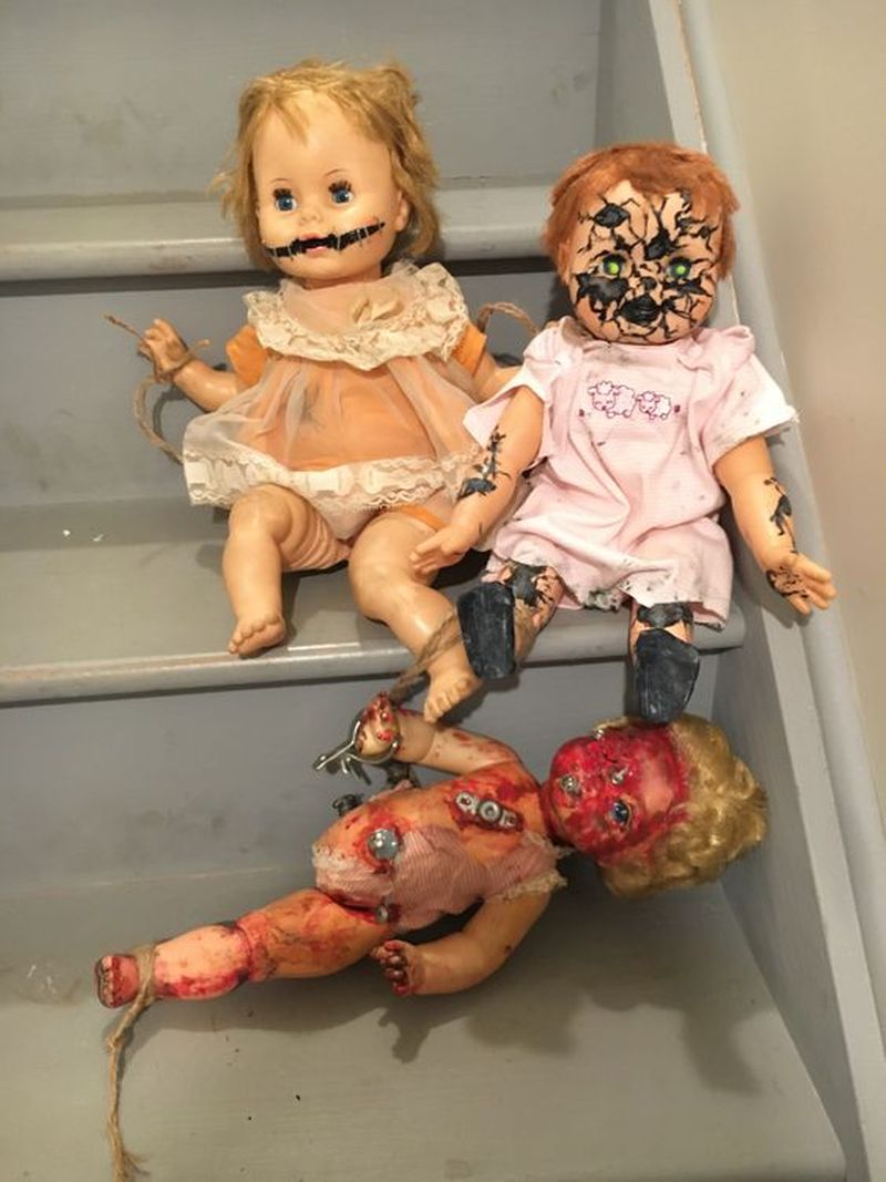 Creepy dolls lying on staircase