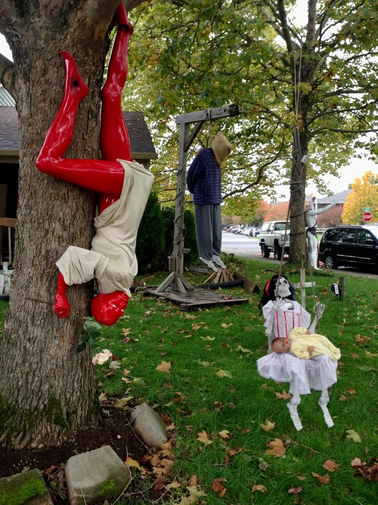 Hanging man and a lady holding a baby creepy doll Halloween decor