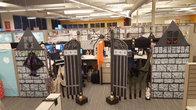 Office cubicle turned into cemetery with an artificial gate and crashing witch prop