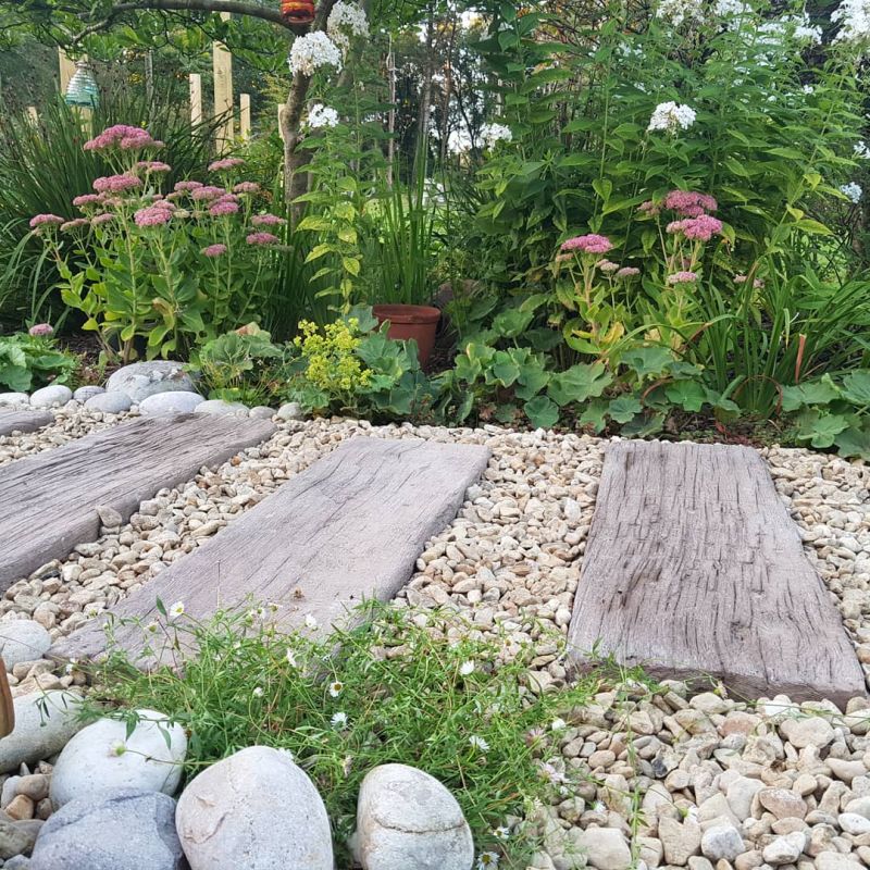 Concrete railway sleepers set in gravel turn out as a beautiful path for garden