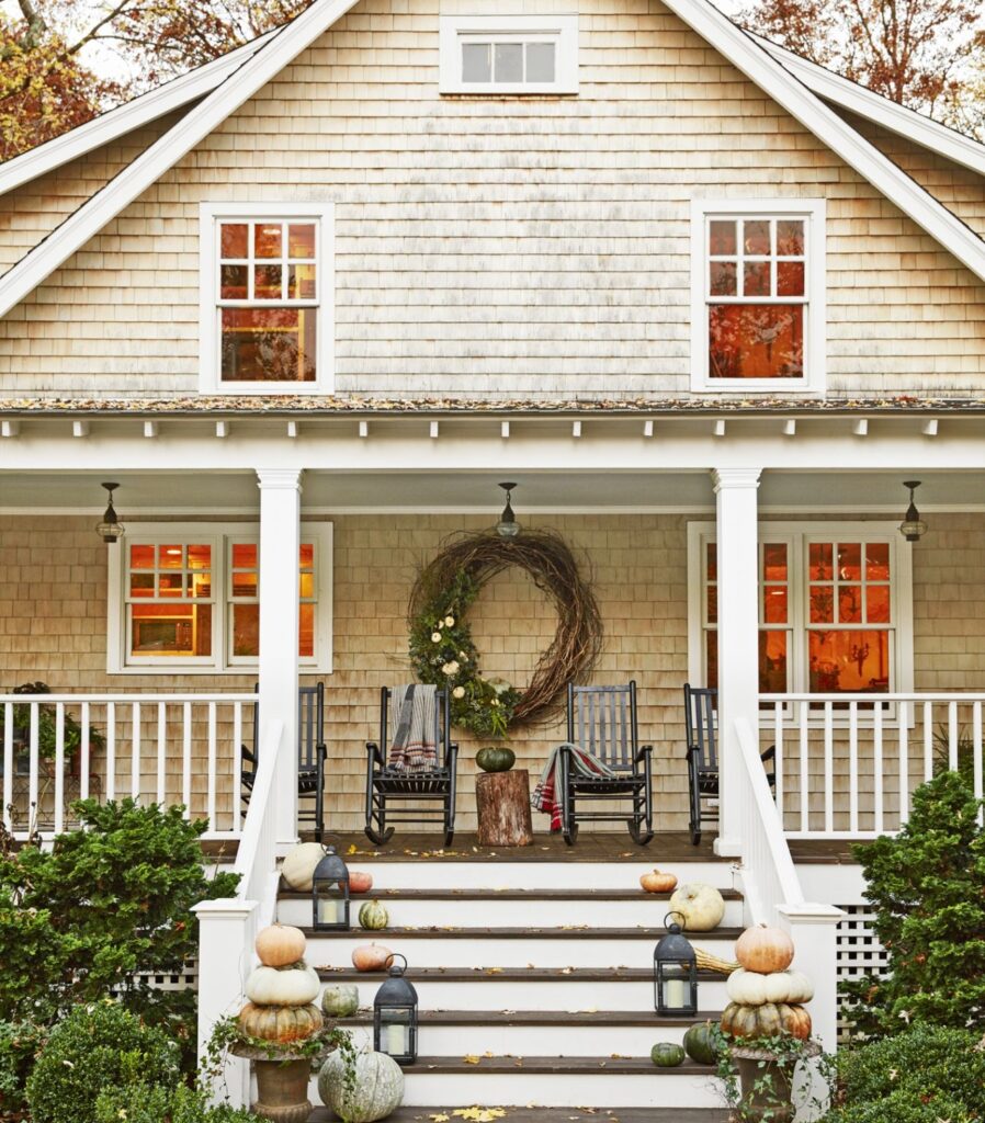 Fall porch decoration with pumpkins on stairs 