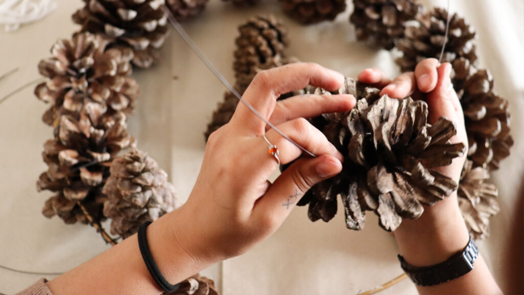 Tie-Pinecones-to-Wire-Wreath