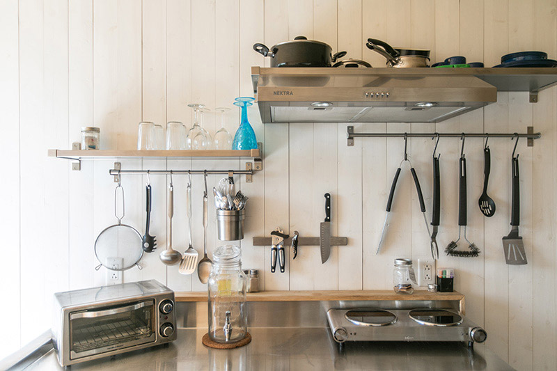 shipping container cabin kitchen with utensils 