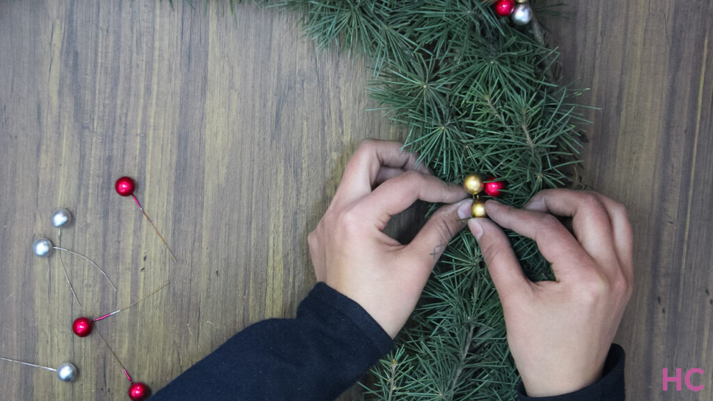 Add colorful berries to the wreath