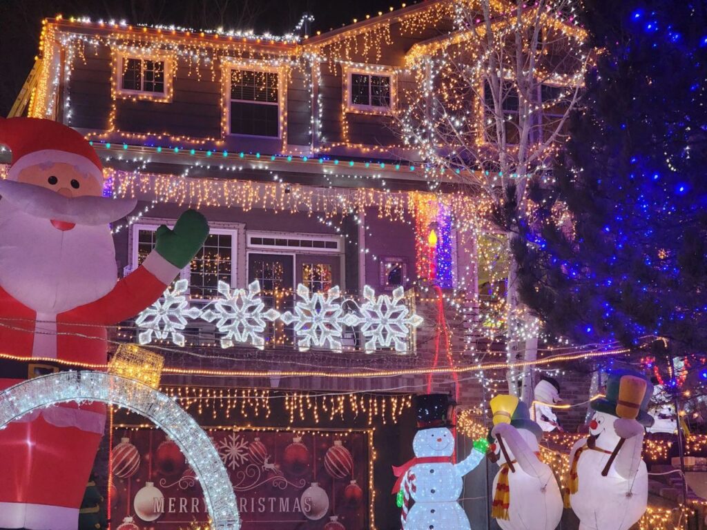 giant Santa and snowman inflatables and large snowflake lights exterior house