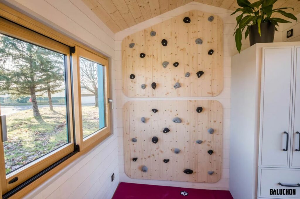 Baluchon's House of Happiness tiny house on wheels features a climbing wall