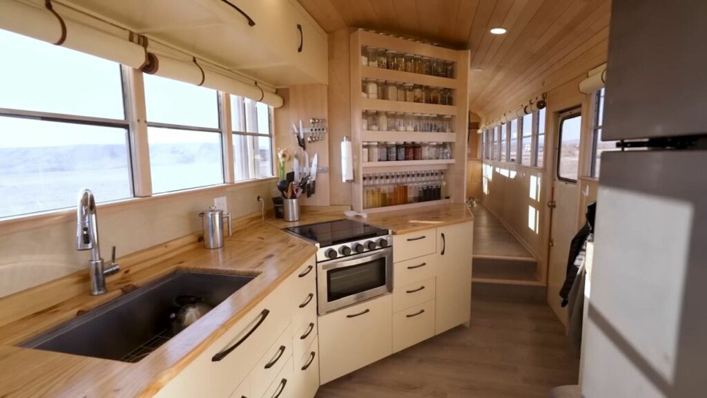 Couple Turns 40-ft School Bus into Luxury RV with Large Pantry in Kitchen