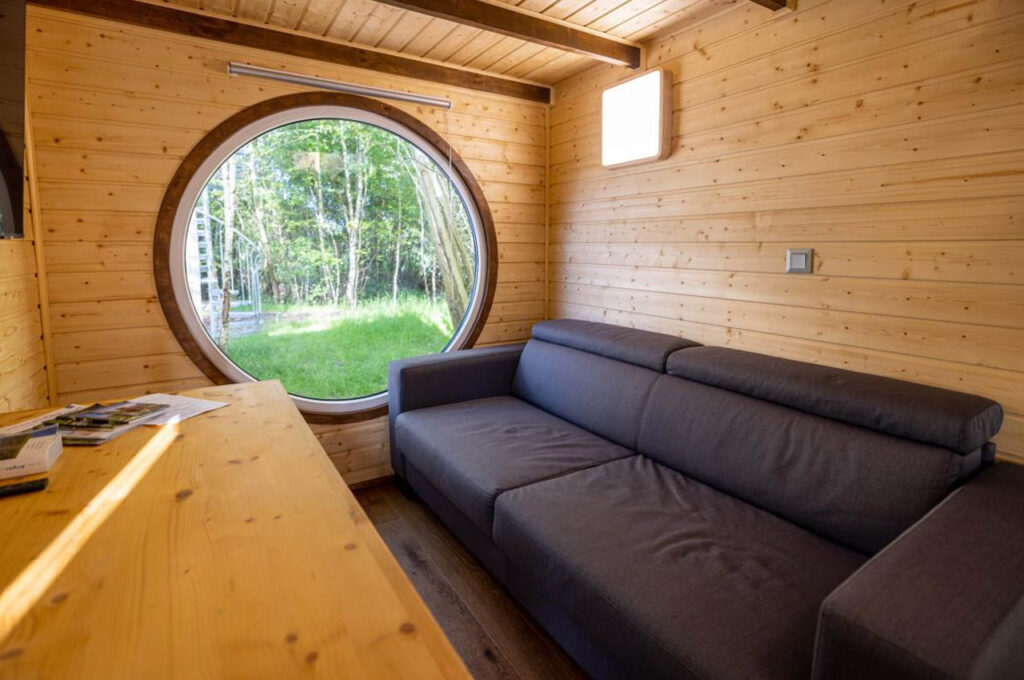 Living room of Dufour Tiny House on Wheels shelf by Berghaus