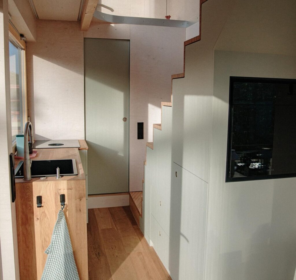 Kitchen- storage integrated stairs- bathroom door