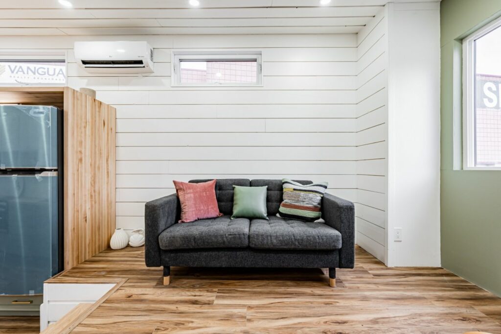 Sofa in the living room of Pine Needle Tiny House by Acorn Tiny Homes