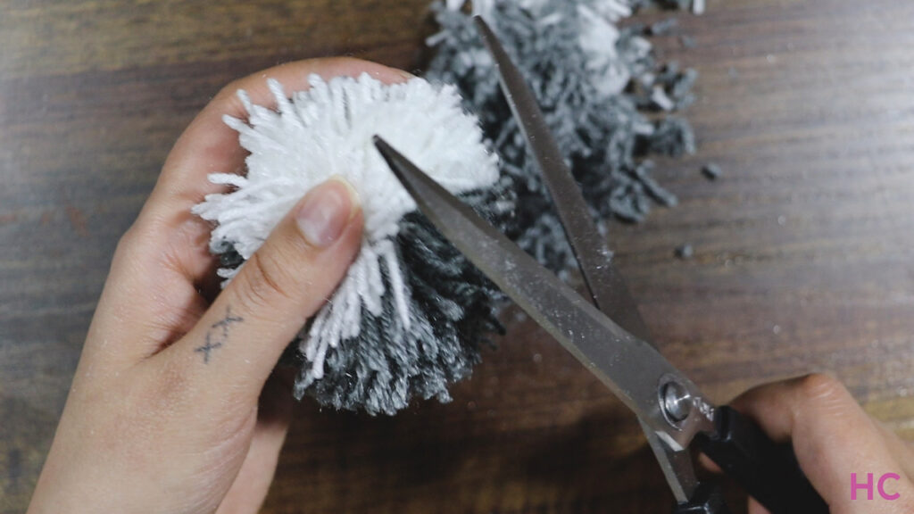 trim-down-the-yarn-jutting-out-until-you-have-a-round,-fluffy-sphere