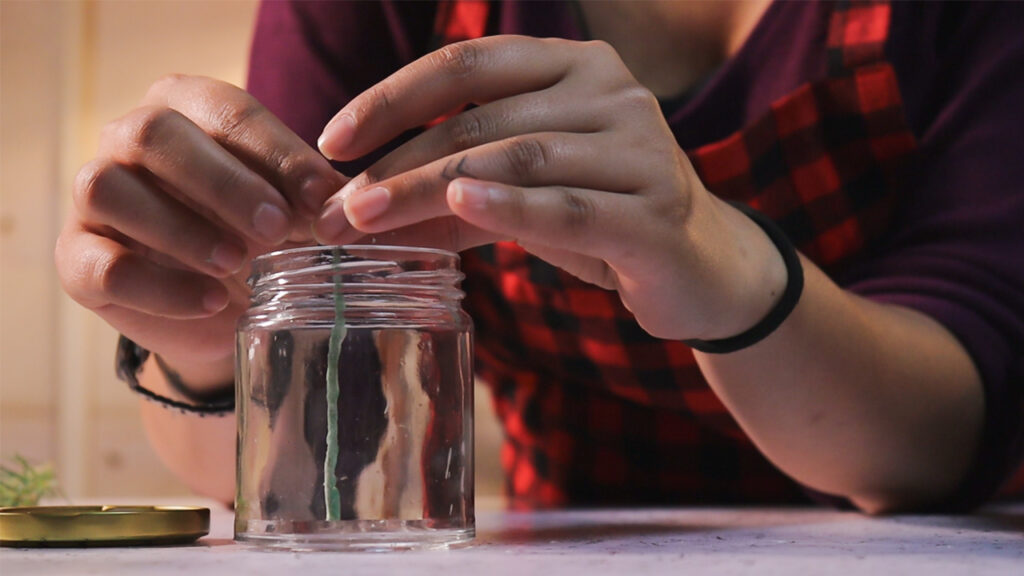 Place the wick in the container