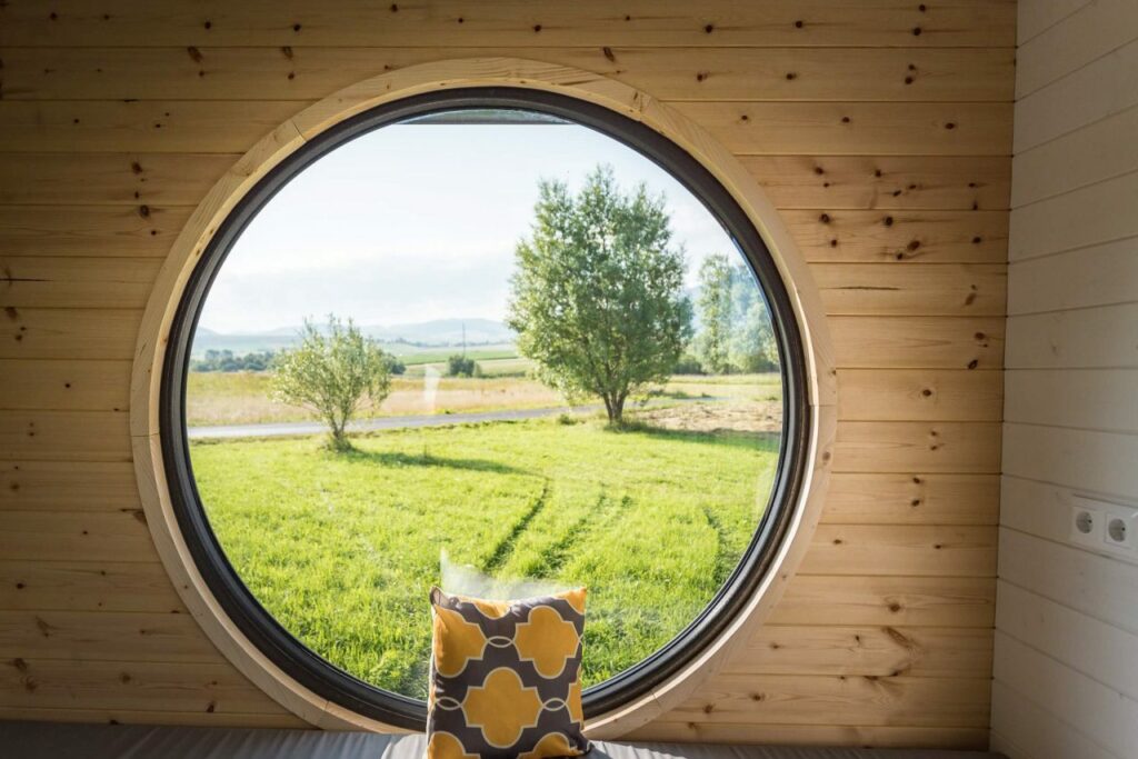 Riverside-Tiny-House-Gorgeous views from porthole window