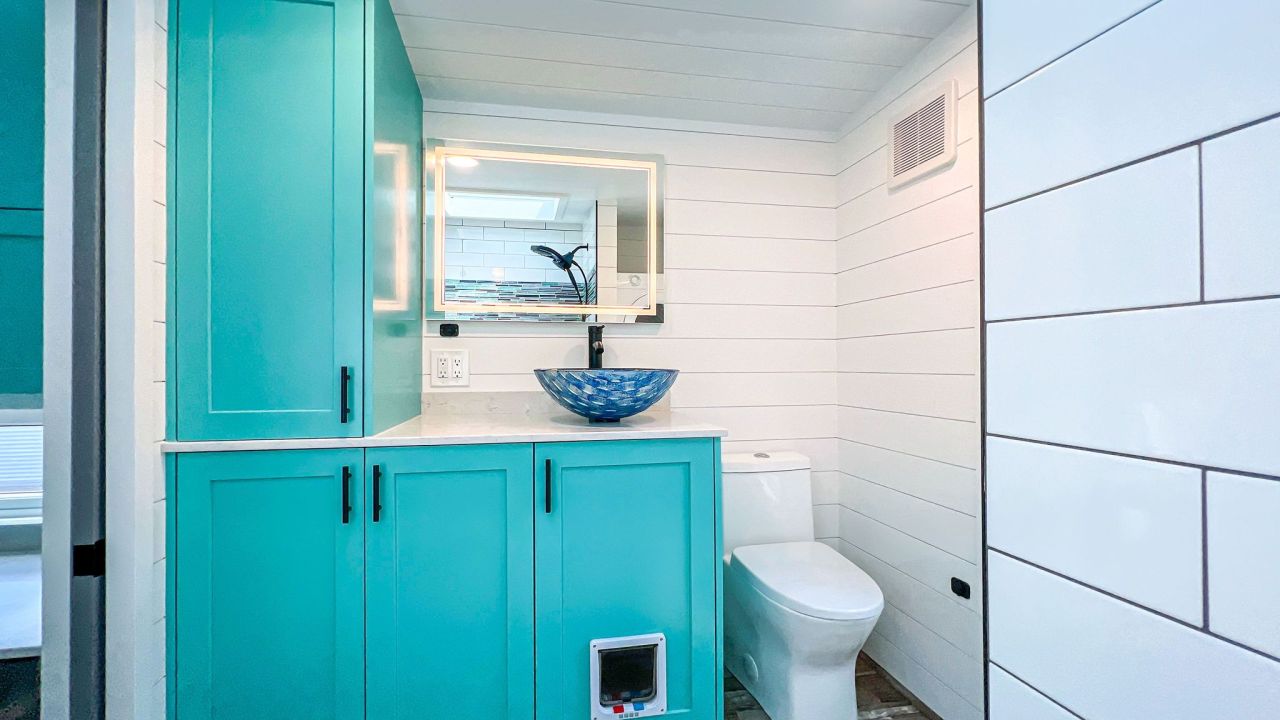 Wave tiny house bathroom by Movable Roots Tiny Homes