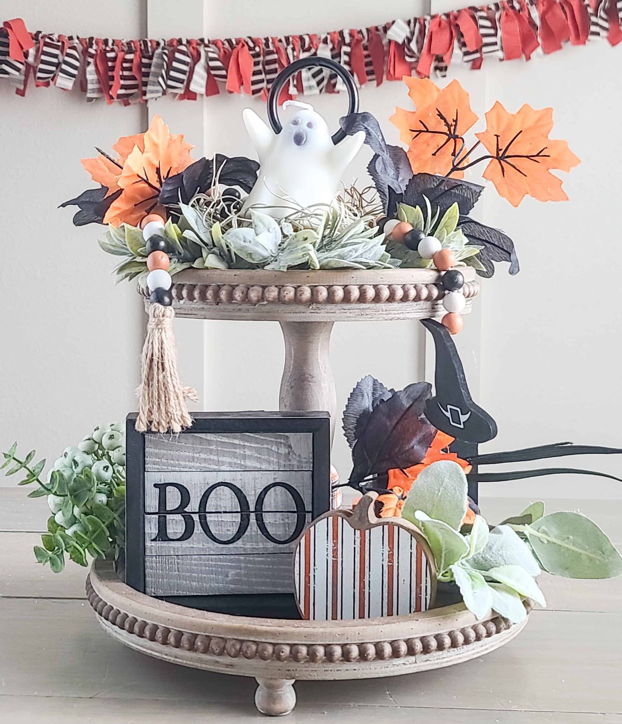 Halloween tiered tray décor with signs, chotchkes and beaded garland