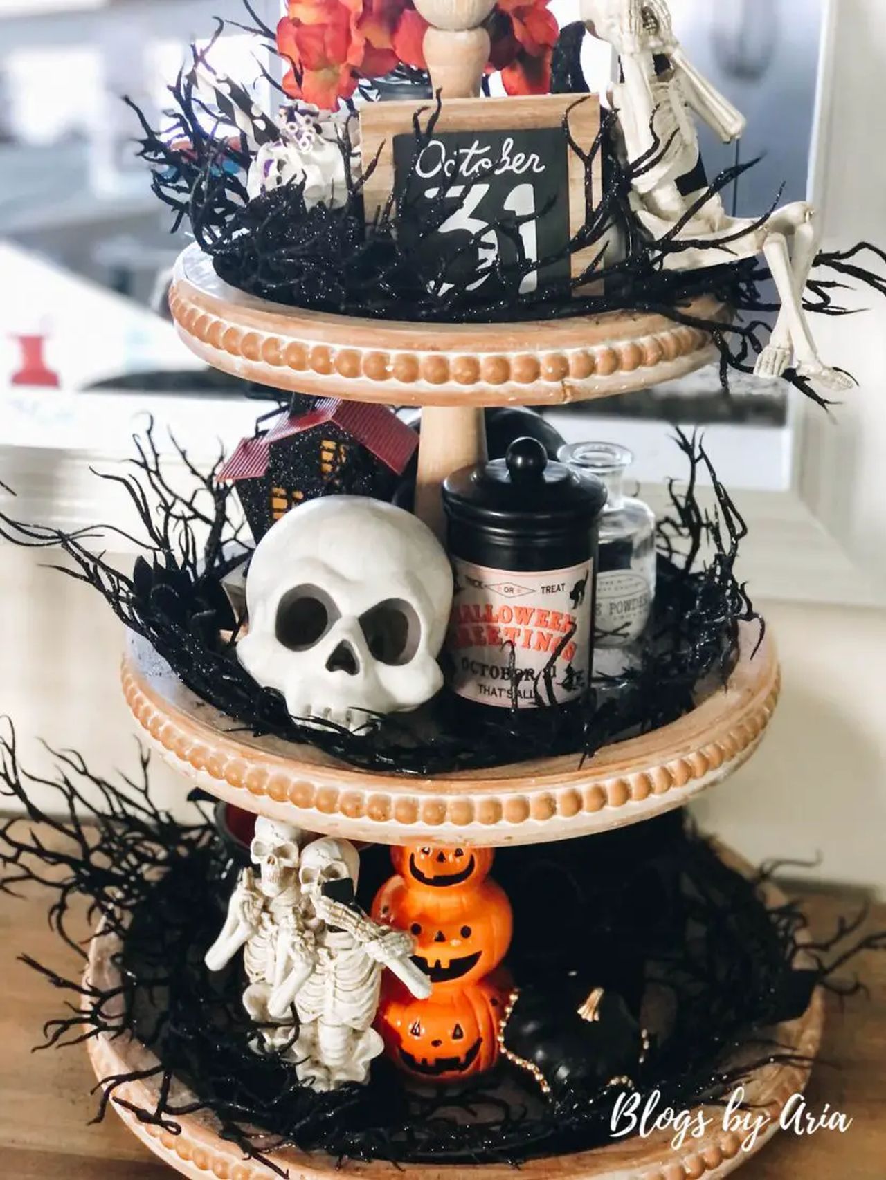 Tiered Tray Draped in Skeletons, pumpkins, and creepy grass is Pretty Eerie