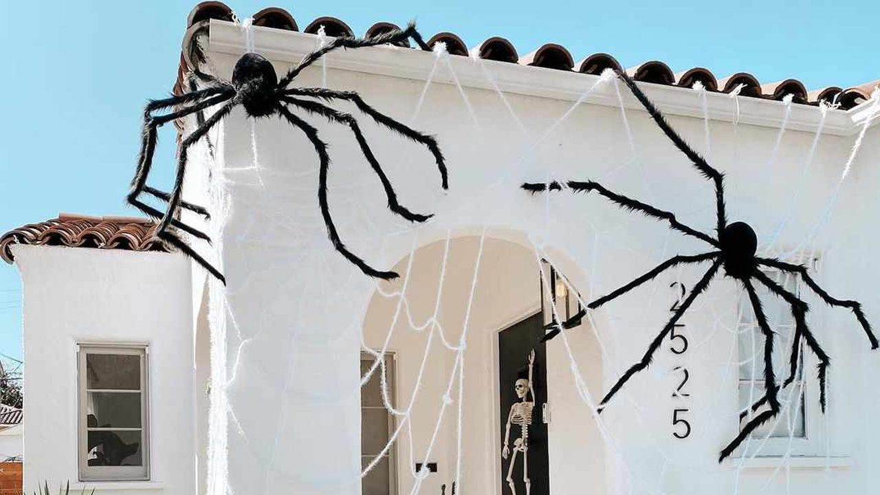 DIY Outdoor Halloween Decorations - Fuzzy Spiders Crawling Down the Roof