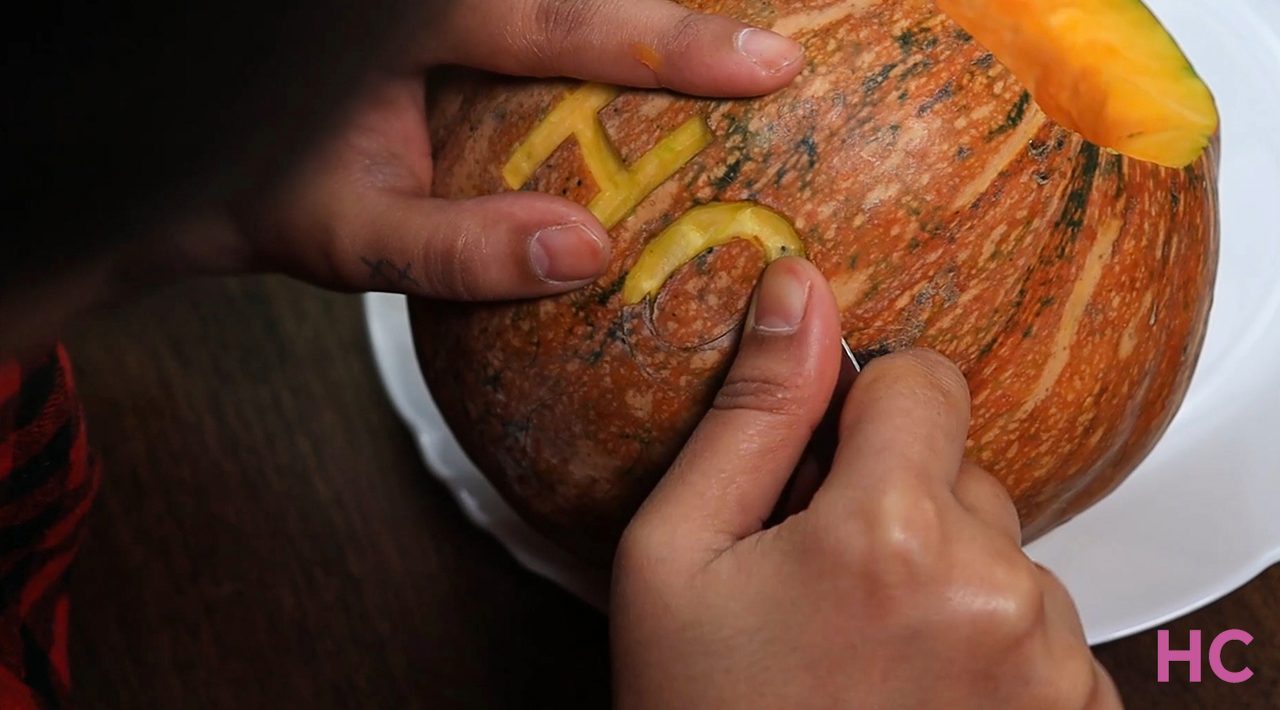 Hocus Pocus Pumpkin Carving - start peeling the skin