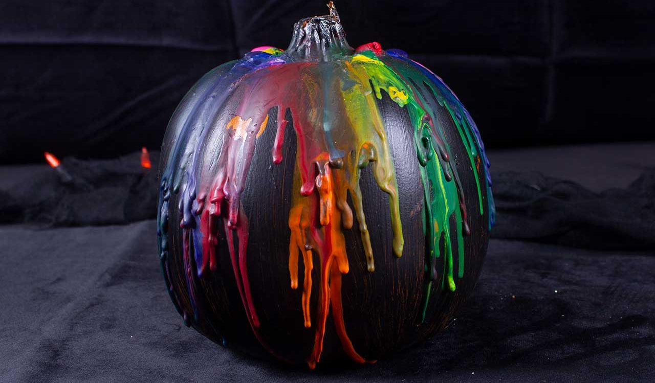 black painted pumpkin with colorful melted wax