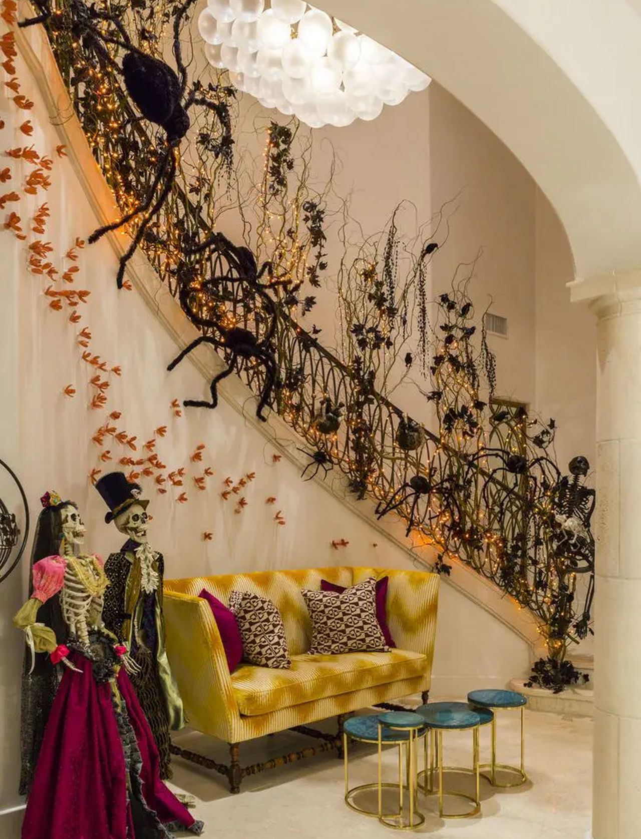 halloween staircase decor using twigs, spiders and skeleton couple