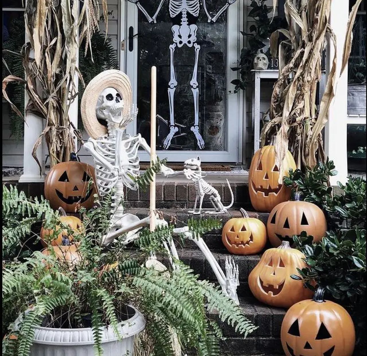 outdoor staircase decor for halloween using human and dog sekleton