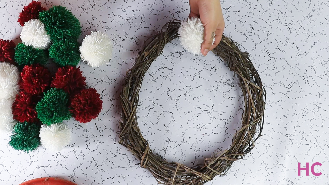 Pom Pom Christmas Wreath - begin gluing pom pom on wreath