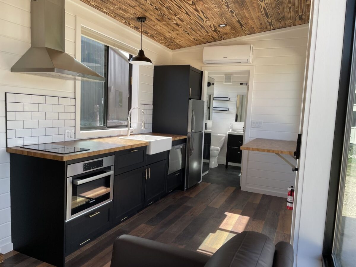 Lodge Tiny House has Burnt Wood Interior, Fireplace, Dishwasher