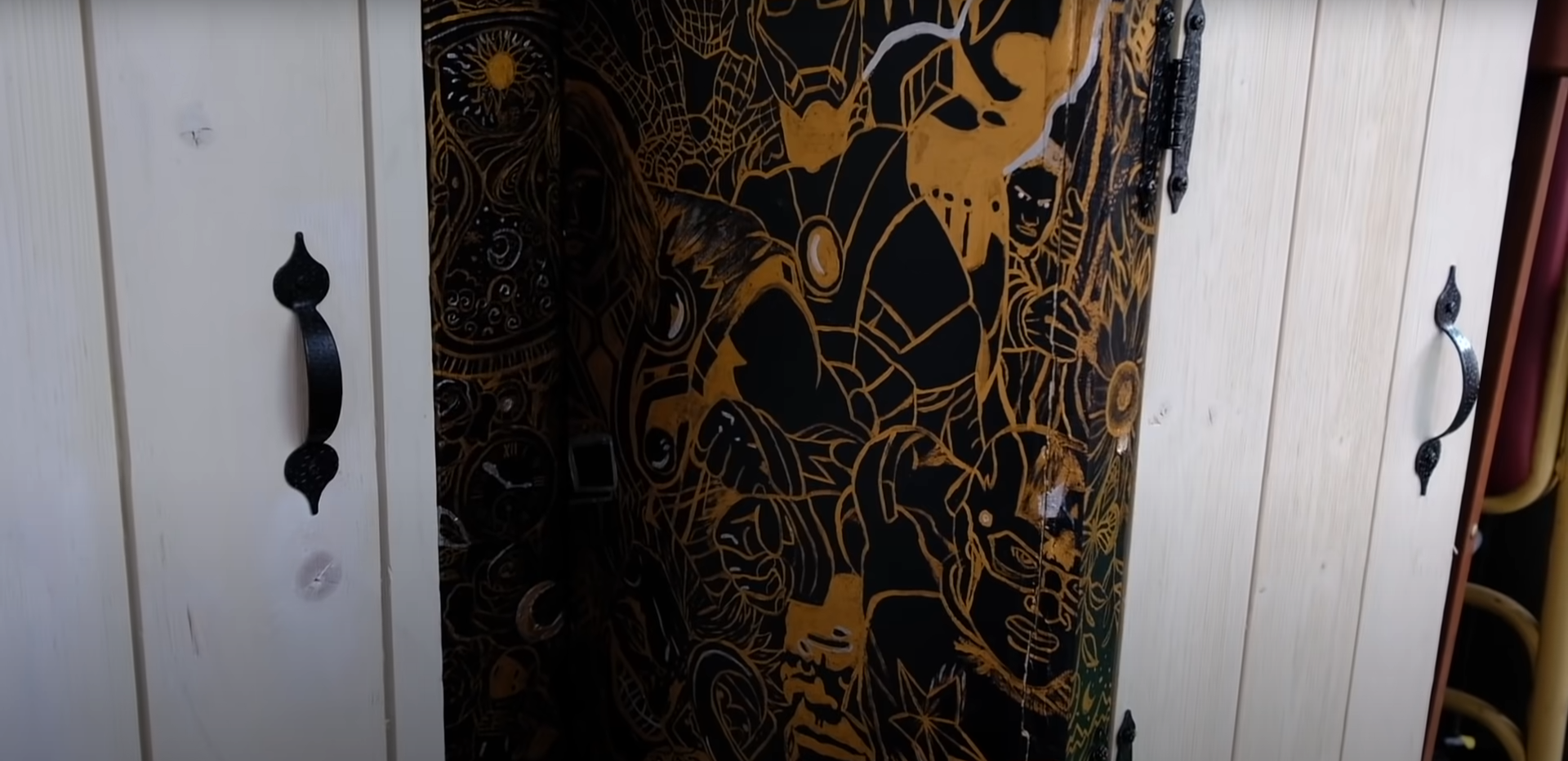 Loki Skoolie with marvel themed walls in the kitchen 