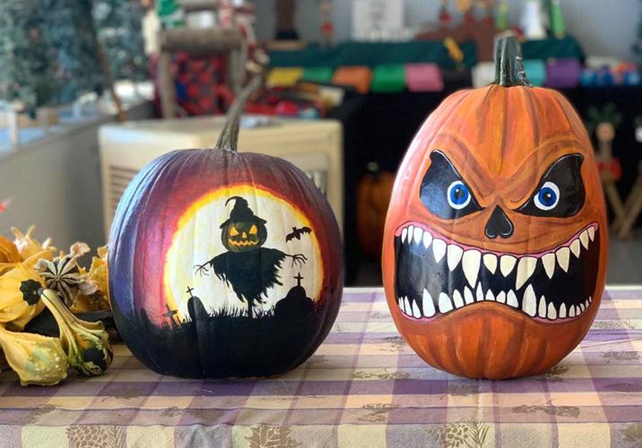 A silhouette scarecrow and a scary face pumpkin