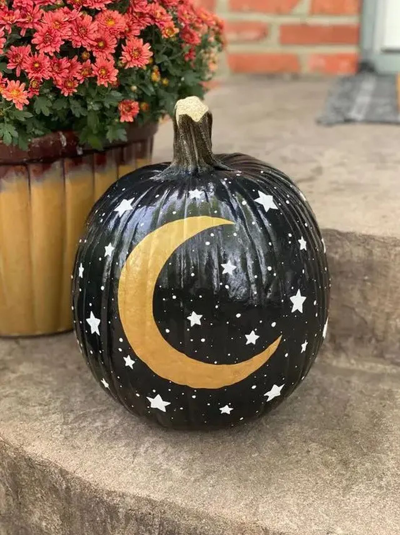Black Halloween pumpkin with little stars and a gold moon