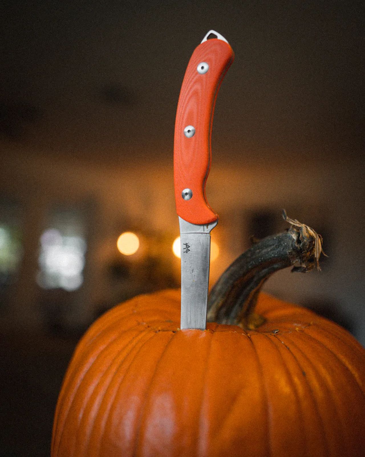 Cheese knives stabbed into pumpkins