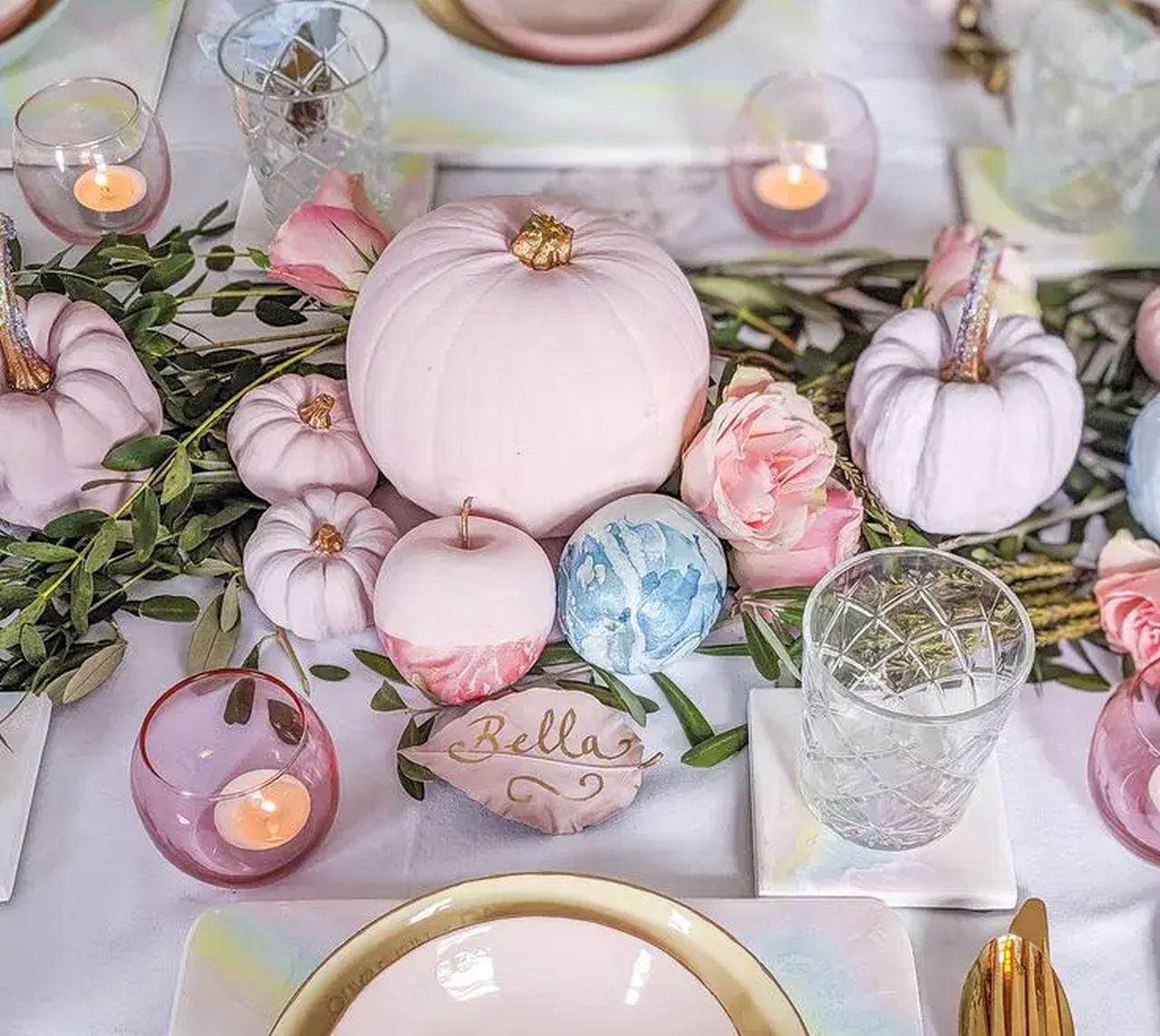 Pastel table decor is done with lilac and blush pumpkins
