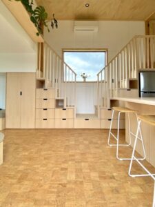 Use the space under the stairs for cabinets, shelves, or even a small closet in a tiny house