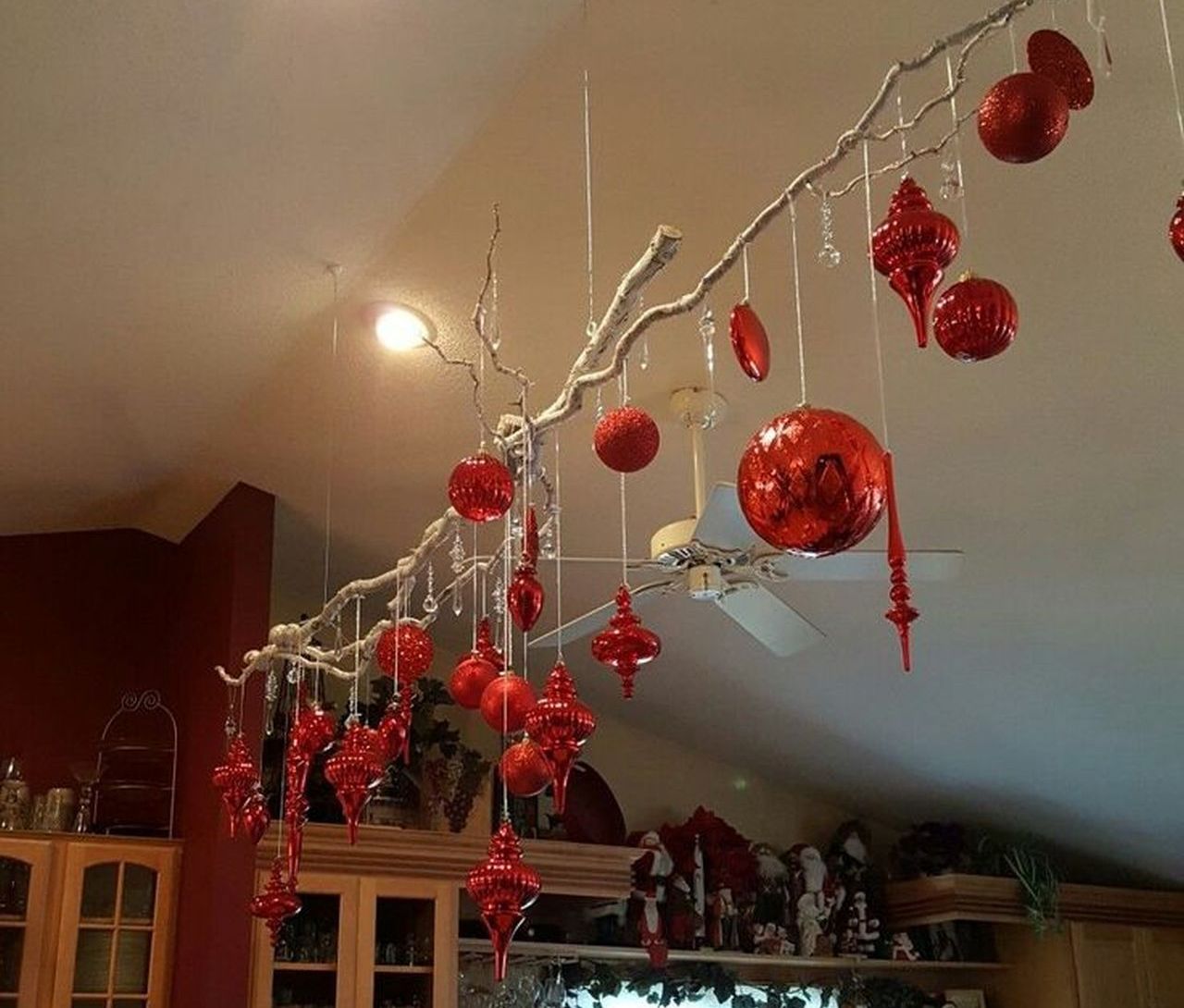 Paint your branch in white color and hang glittering red ornaments- 1