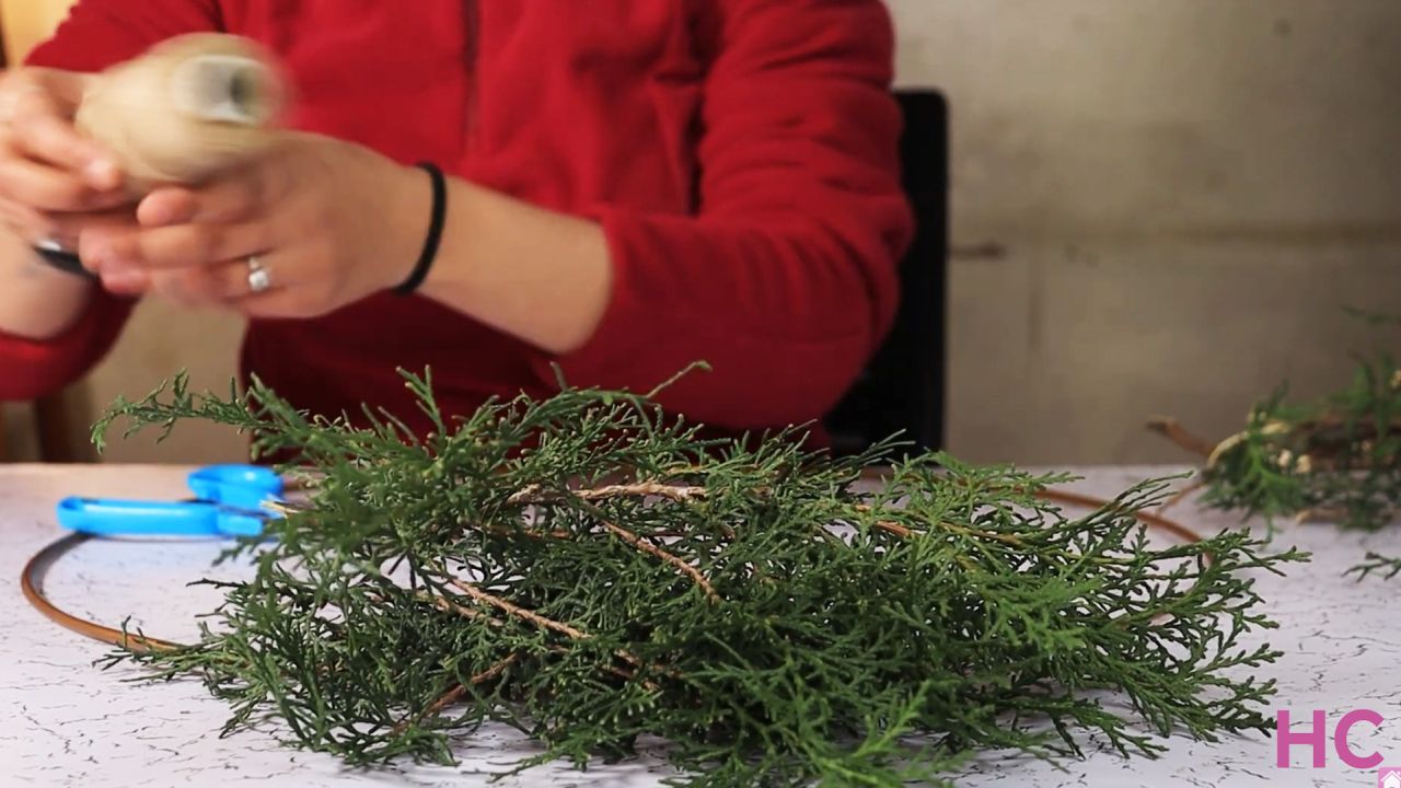 Last-Minute Evergreen Cypress Wreath - start tying bunches of greenery to wreath base - 1