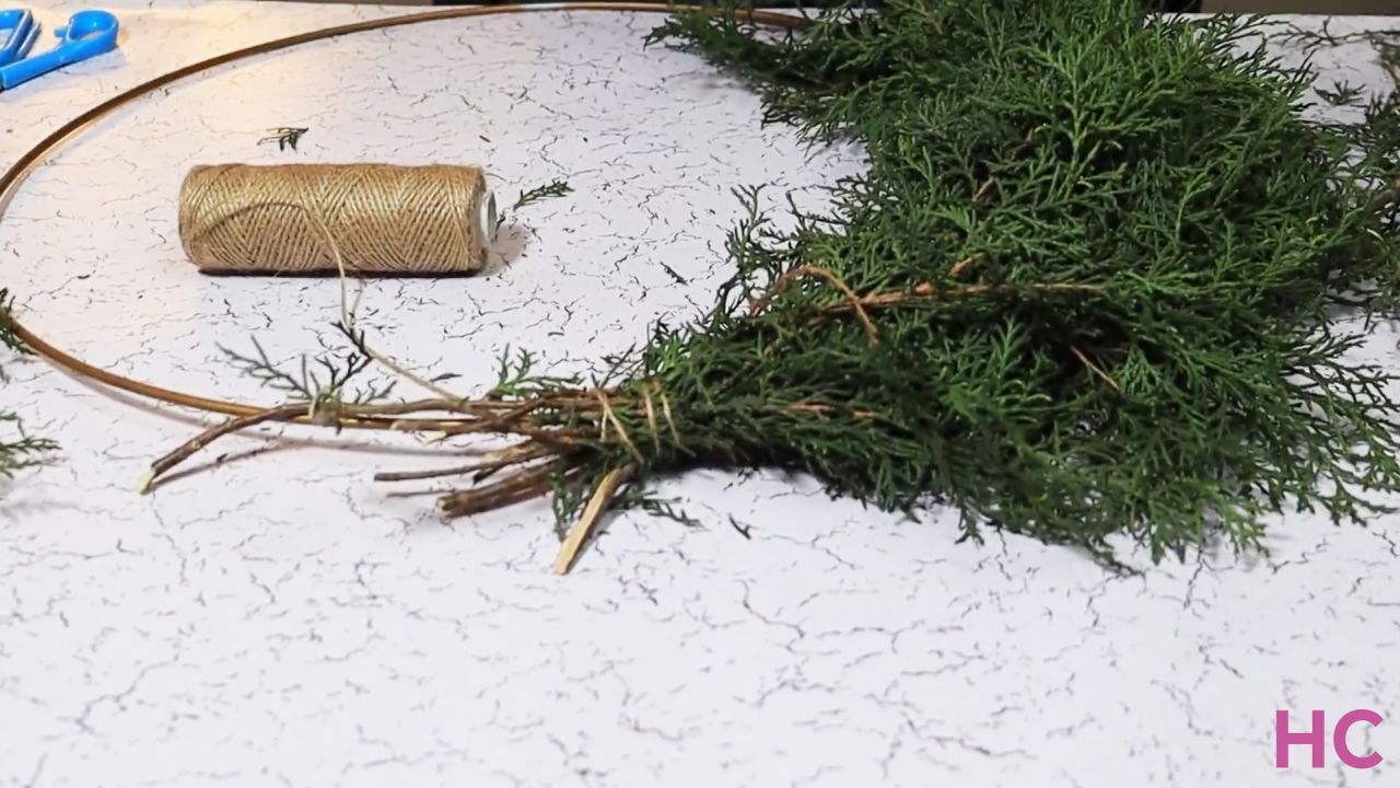 Last-Minute Evergreen Cypress Wreath - start tying bunches of greenery to wreath base - 2