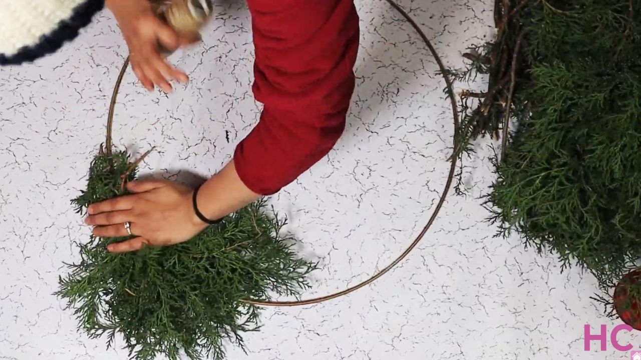 Last-Minute Evergreen Cypress Wreath - start tying bunches of greenery to wreath base